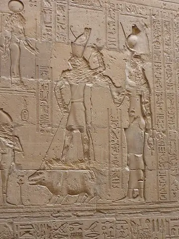 Wall relief of fight between Seth and Horus where Horus, helped by Isis, kill Seth (hippopotamus), temple of Edfu, Egypt