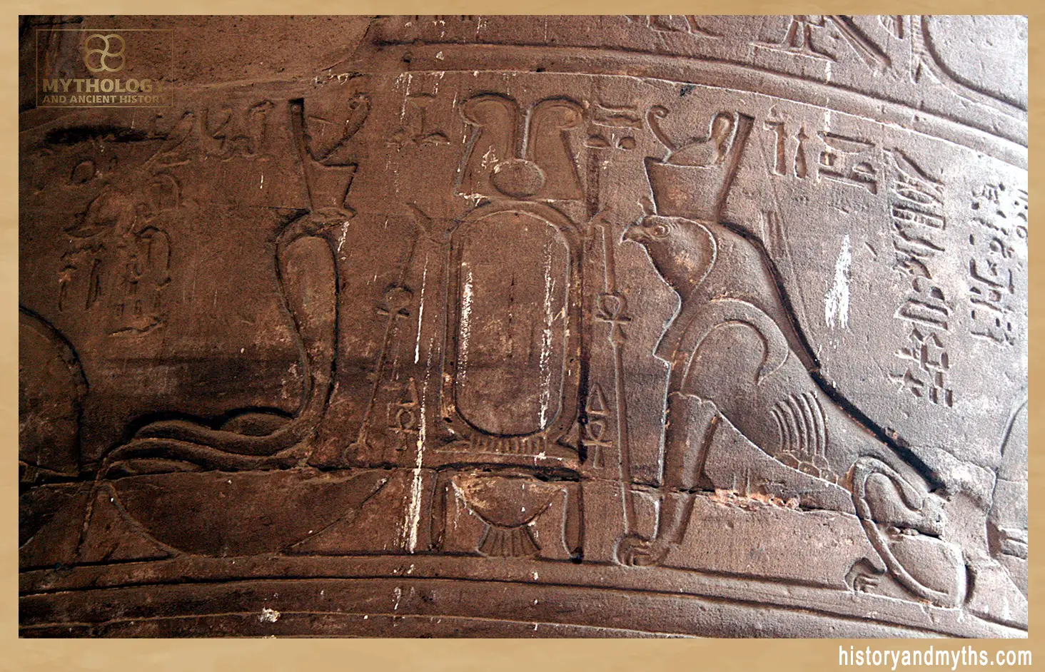 Relief carvings on the outer pylon of the Temple of Edfu showing the cobra-goddess Wadjet beneath her uraeus-symbol, Egypt.