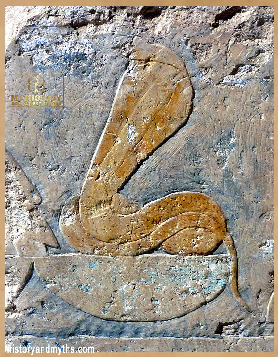 Relief carving of the cobra goddess Wadjet on the second terrace of Hatshepsut’s temple at Deir el-Bahari, showing her protective uraeus form.