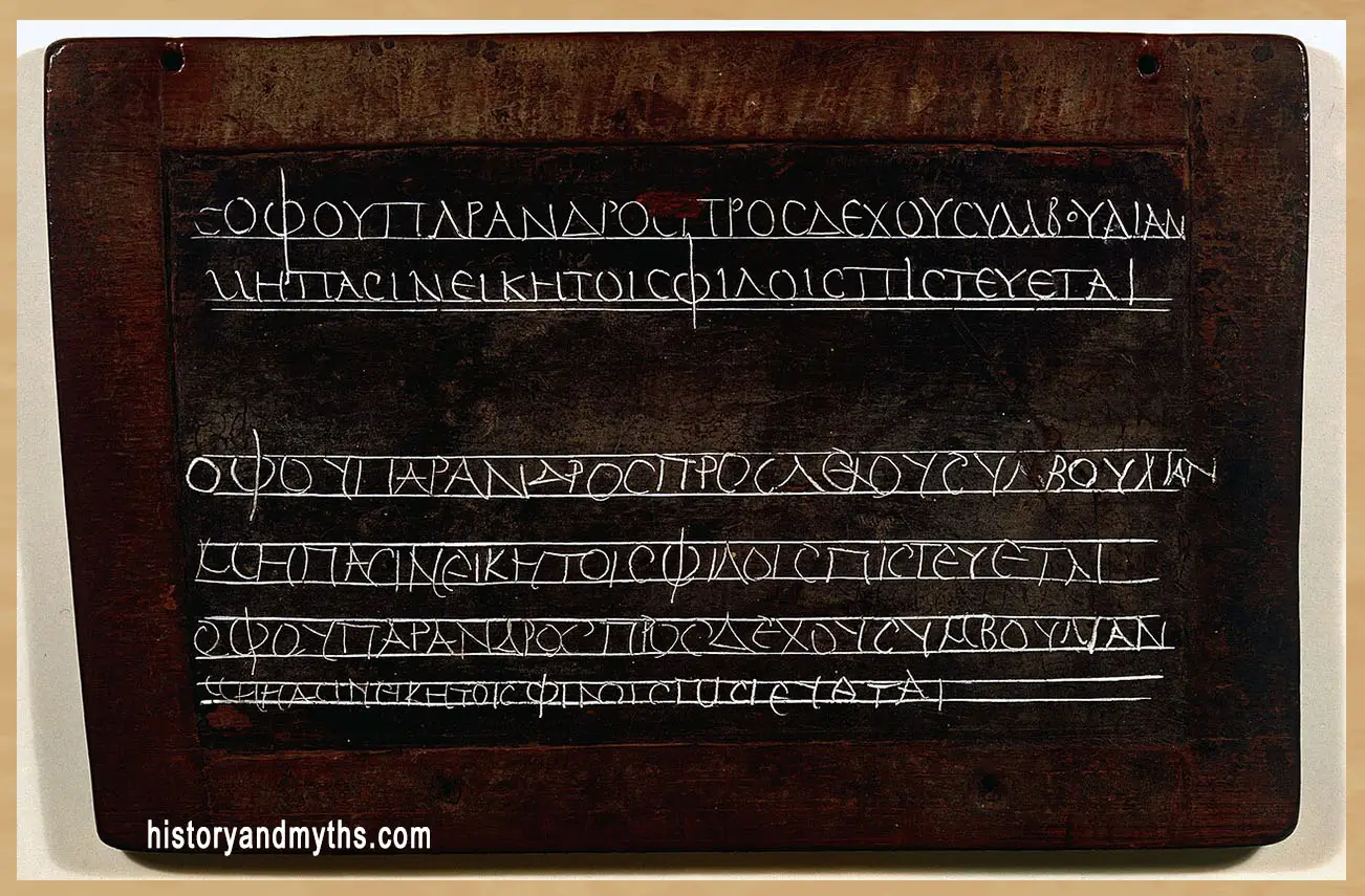 Wax writing tablet used as a Greek student exercise book, showing copying and writing practice in the ancient world