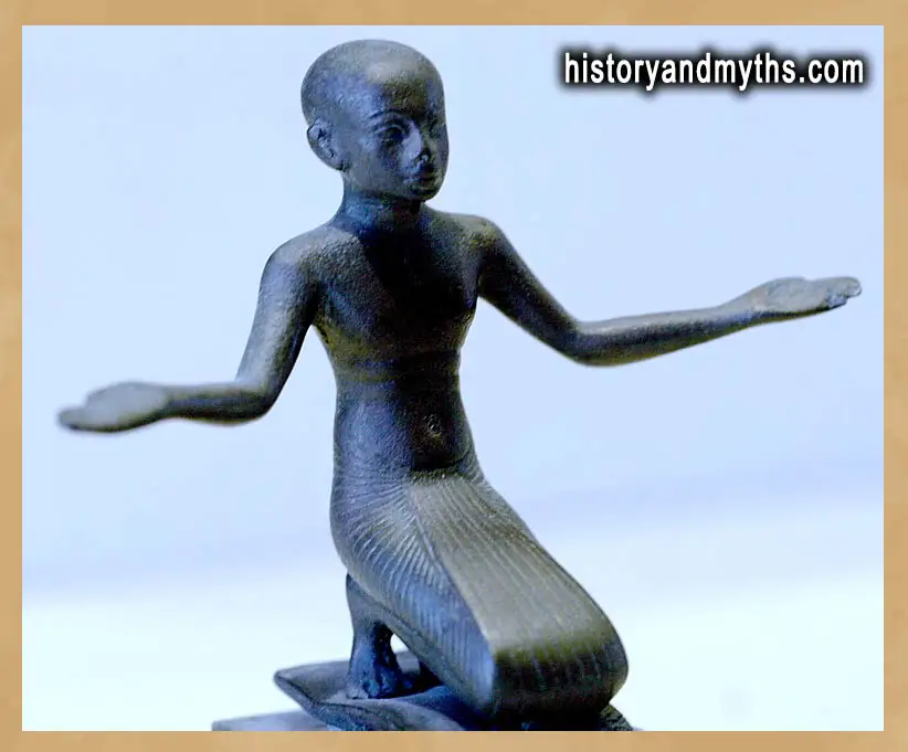 Bronze figurine of a praying man from ancient Egypt in the Louvre Museum