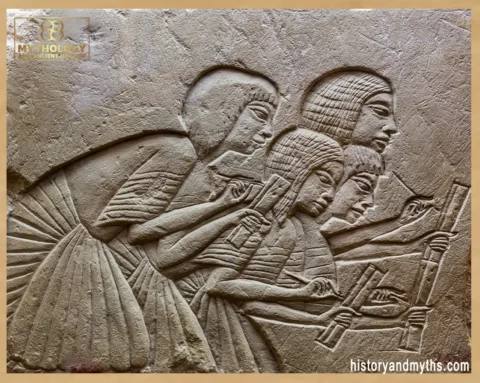Tomb relief fragment depicting four scribes recording words dictated by the pharaoh
