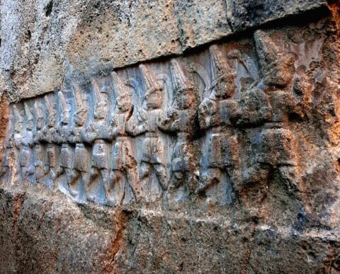 A procession of twelve underworld gods carved into the rock at the Hittite sanctuary of Yazılıkaya, near Hattusa, Turkey. Photo: Ywpark2003. Source: Wikimedia Commons. License: CC0 1.0 (Public Domain).